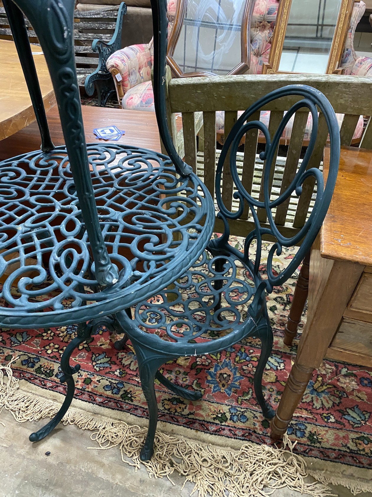 A green painted aluminium cafe table and two chairs